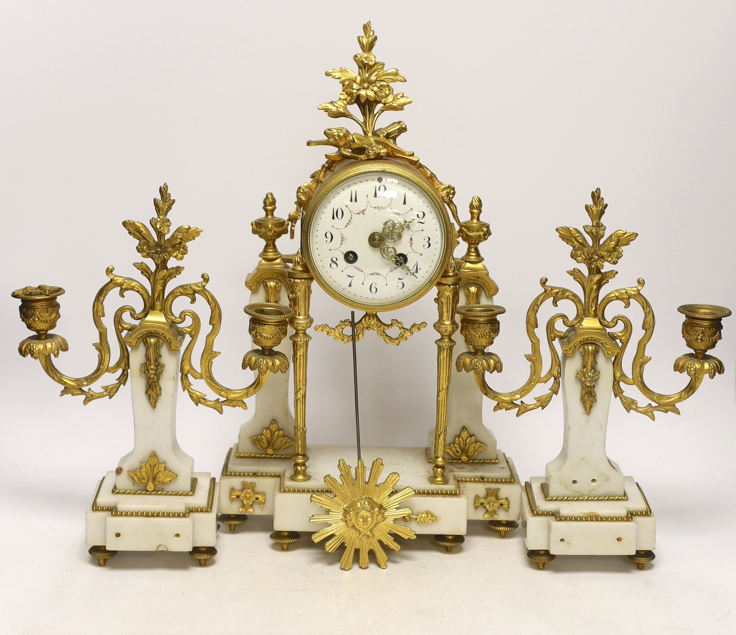 An early 20th century white marble and ormolu clock garniture with Arabic enamelled dial, 42cm high
